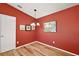 Cozy dining area with hardwood floors and red accent walls at 1280 Mount Vernon Way, The Villages, FL 32162