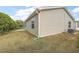 Back of house with large yard and visible AC unit at 1280 Mount Vernon Way, The Villages, FL 32162