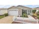 House exterior showcasing a screened porch and white picket fence at 1280 Mount Vernon Way, The Villages, FL 32162