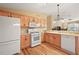 Modern kitchen with ample counter space, light wood cabinets, and a dishwasher at 1280 Mount Vernon Way, The Villages, FL 32162