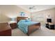 Main bedroom with ceiling fan, large bed, and ample closet space at 1280 Mount Vernon Way, The Villages, FL 32162