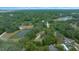 Aerial view showing home, pond, and surrounding landscape at 13588 Sw 105Th Pl, Dunnellon, FL 34432