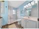 Bathroom with light blue walls and a shower/tub combo at 13588 Sw 105Th Pl, Dunnellon, FL 34432