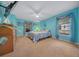 Bedroom with light blue walls, carpeted floor, and a ceiling fan at 13588 Sw 105Th Pl, Dunnellon, FL 34432