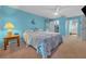 Primary bedroom with light blue walls and ceiling fan at 13588 Sw 105Th Pl, Dunnellon, FL 34432