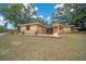 House exterior showcasing a well-maintained lawn and landscaping at 13588 Sw 105Th Pl, Dunnellon, FL 34432