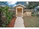 House exterior with walkway and well-maintained landscaping at 13588 Sw 105Th Pl, Dunnellon, FL 34432