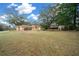 Single-story house with a large yard and mature trees at 13588 Sw 105Th Pl, Dunnellon, FL 34432