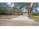 Front view of house with driveway and landscaping at 13588 Sw 105Th Pl, Dunnellon, FL 34432