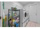 Laundry room with washer, dryer, and storage shelving at 13588 Sw 105Th Pl, Dunnellon, FL 34432