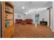 Bright living room with hardwood floors, leather couches, and a fireplace at 13588 Sw 105Th Pl, Dunnellon, FL 34432