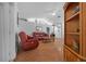 Living room features hardwood floors and red leather furniture at 13588 Sw 105Th Pl, Dunnellon, FL 34432