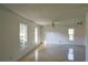 Spacious bedroom with tile flooring and multiple windows at 13635 Berkshire Ct, Grand Island, FL 32735