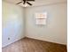 Simple bedroom with ceiling fan and window at 13635 Berkshire Ct, Grand Island, FL 32735