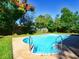 Inviting kidney-shaped pool with surrounding yard at 13635 Berkshire Ct, Grand Island, FL 32735