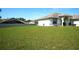 Expansive lawn view highlighting the home's outdoor space, with a glimpse of the house's architecture at 137 Country Lakes Cir, Groveland, FL 34736