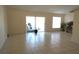 Spacious living room with tiled flooring, large windows, and sliding doors, perfect for gatherings and relaxation at 137 Country Lakes Cir, Groveland, FL 34736