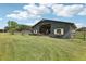 Black barn with white accents, flower boxes, and open stalls at 1392 Sw 103Rd Ave, Webster, FL 33597