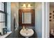 Small powder room with pedestal sink and decorative mirror at 1392 Sw 103Rd Ave, Webster, FL 33597