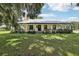 Farmhouse exterior with wrap-around porch at 1392 Sw 103Rd Ave, Webster, FL 33597