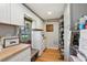 White kitchen cabinets, wood floors, and a window overlooking the farm at 1392 Sw 103Rd Ave, Webster, FL 33597