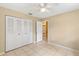 Spacious bedroom with tile floors and mirrored closet doors at 1395 Morningside St, Mount Dora, FL 32757