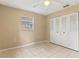 Bedroom with tile floors, double door closet and window at 1395 Morningside St, Mount Dora, FL 32757