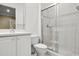 Clean bathroom with white vanity, toilet, and glass shower at 14 Camino Real Blvd # 14, Howey In The Hills, FL 34737