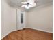 Bright bedroom featuring hardwood floors and ceiling fan at 14 Camino Real Blvd # 14, Howey In The Hills, FL 34737