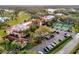 Aerial view of hotel building with parking and tennis courts at 14 Camino Real Blvd # 14, Howey In The Hills, FL 34737