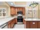 Bright kitchen with stainless steel appliances and wood cabinets at 14 Camino Real Blvd # 14, Howey In The Hills, FL 34737