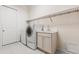 Laundry room with washer, dryer, and utility sink at 14 Camino Real Blvd # 14, Howey In The Hills, FL 34737