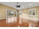 Living room with hardwood floors and sliding glass doors to a deck at 14 Camino Real Blvd # 14, Howey In The Hills, FL 34737