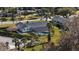 Aerial view of the house, highlighting the pool and its screened enclosure at 1401 Lake Shore Blvd, Tavares, FL 32778