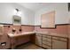 Retro bathroom with pink tile, large vanity and window at 1401 Lake Shore Blvd, Tavares, FL 32778