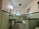 Vintage bathroom with mint green tile and a bathtub at 1401 Lake Shore Blvd, Tavares, FL 32778