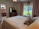 Charming bedroom with a queen-size bed and view at 1401 Lake Shore Blvd, Tavares, FL 32778