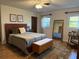 Spacious bedroom with mid-century modern furniture and hardwood floors at 1401 Lake Shore Blvd, Tavares, FL 32778