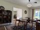 Mid-century modern dining room with glass table and woven chairs at 1401 Lake Shore Blvd, Tavares, FL 32778