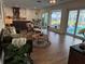 Spacious living area with hardwood floors, pool view, and mid-century furniture at 1401 Lake Shore Blvd, Tavares, FL 32778