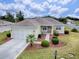 Single-Gathering home with a two-car garage and nicely landscaped front yard at 14267 Se 85Th Ter, Summerfield, FL 34491