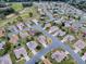 Aerial view of a residential community with numerous homes and a golf course at 14267 Se 85Th Ter, Summerfield, FL 34491