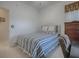 Guest bedroom with striped bedding and dresser at 14267 Se 85Th Ter, Summerfield, FL 34491