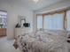 Main bedroom with a king-size bed, bay window, and dresser at 14267 Se 85Th Ter, Summerfield, FL 34491