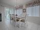 Bright dining room with a table for six and access to a screened porch at 14267 Se 85Th Ter, Summerfield, FL 34491