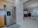 Kitchen features stainless steel refrigerator and wood cabinets at 14267 Se 85Th Ter, Summerfield, FL 34491