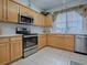 Kitchen with stainless steel appliances and light wood cabinets at 14267 Se 85Th Ter, Summerfield, FL 34491