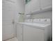 Laundry room with washer, dryer, and cabinets at 14267 Se 85Th Ter, Summerfield, FL 34491