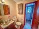 Bathroom with toilet, sink, and access to a separate shower at 1503 Woodlyn Dr, Leesburg, FL 34748