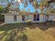 Ranch style home with mature trees and a well-maintained lawn at 1503 Woodlyn Dr, Leesburg, FL 34748